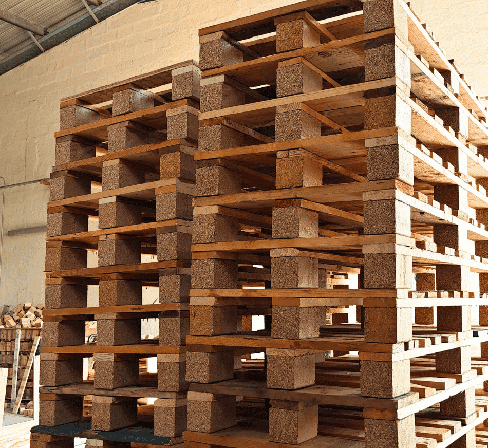 Pallets stacked for storage at PalletBiz warehouse, ready for distribution.