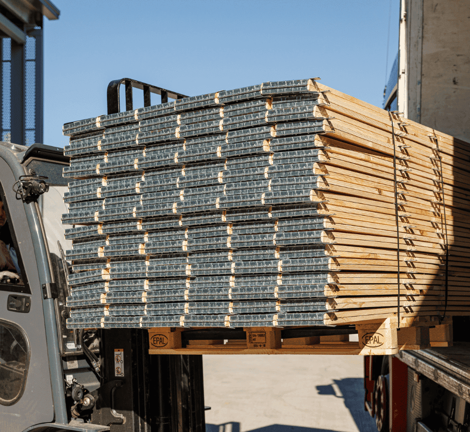 Industrial pallet collars loaded on forklift for shipping and distribution.