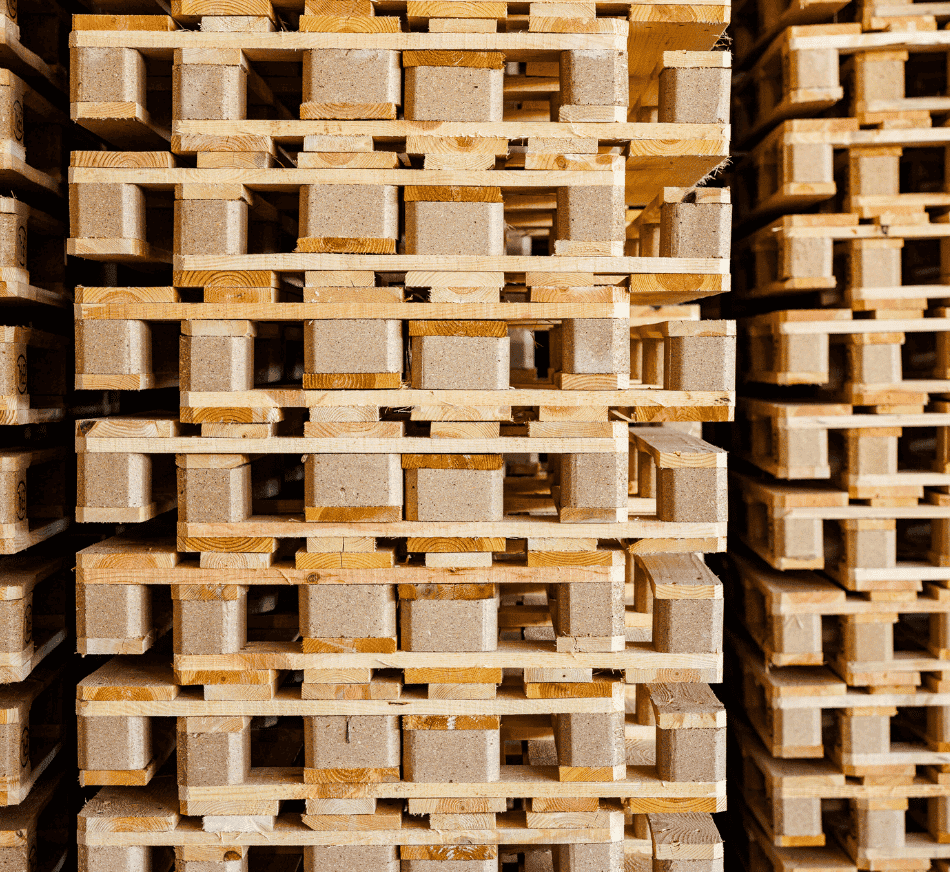 Stacked wooden pallets with pressed blocks for shipping and storage.