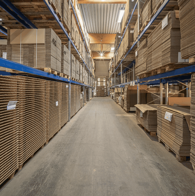 Indoor warehouse with organised pallet storage for packaging and logistics.