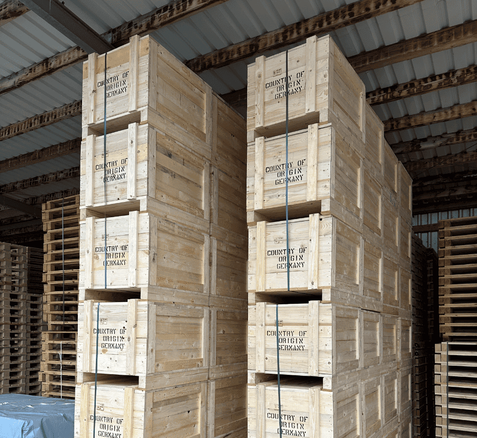 Stacked wooden boxes in a warehouse for logistics and storage solutions at PalletBiz.