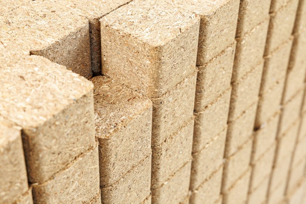 A pile of wooden compressed blocks stacked together.